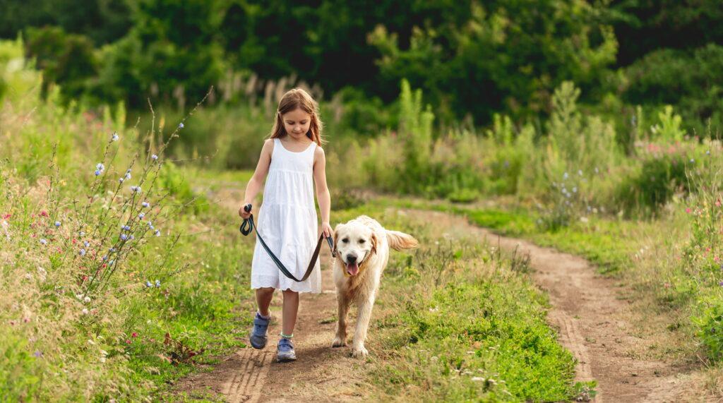 Cute little girl running with dog